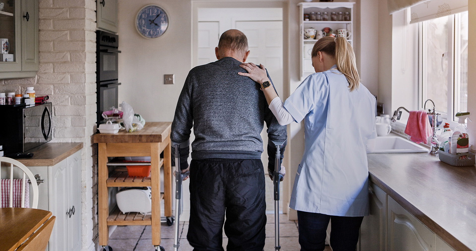 An elderly veteran receiving care from a female care working at home.