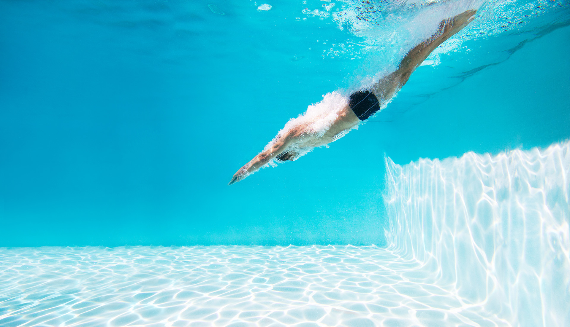 A veteran plunging into a swimming pool.