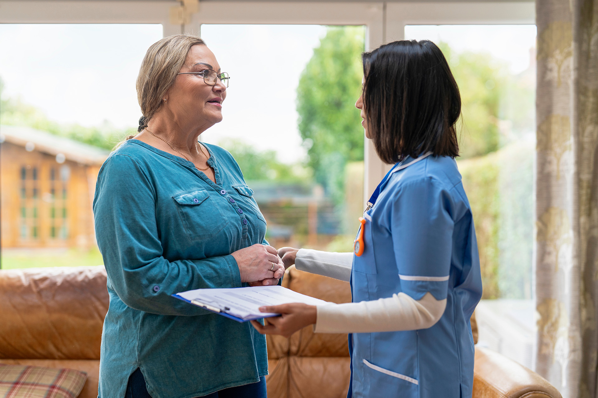 A care worker visiting a carer's home, showing the help for carers in Northern Ireland available through a Carer's Assessment.