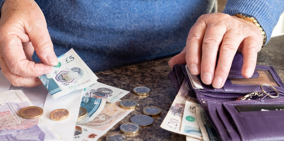 A veteran counting money from a wallet, outlining how a Budgeting Loan could provide financial support for veterans.