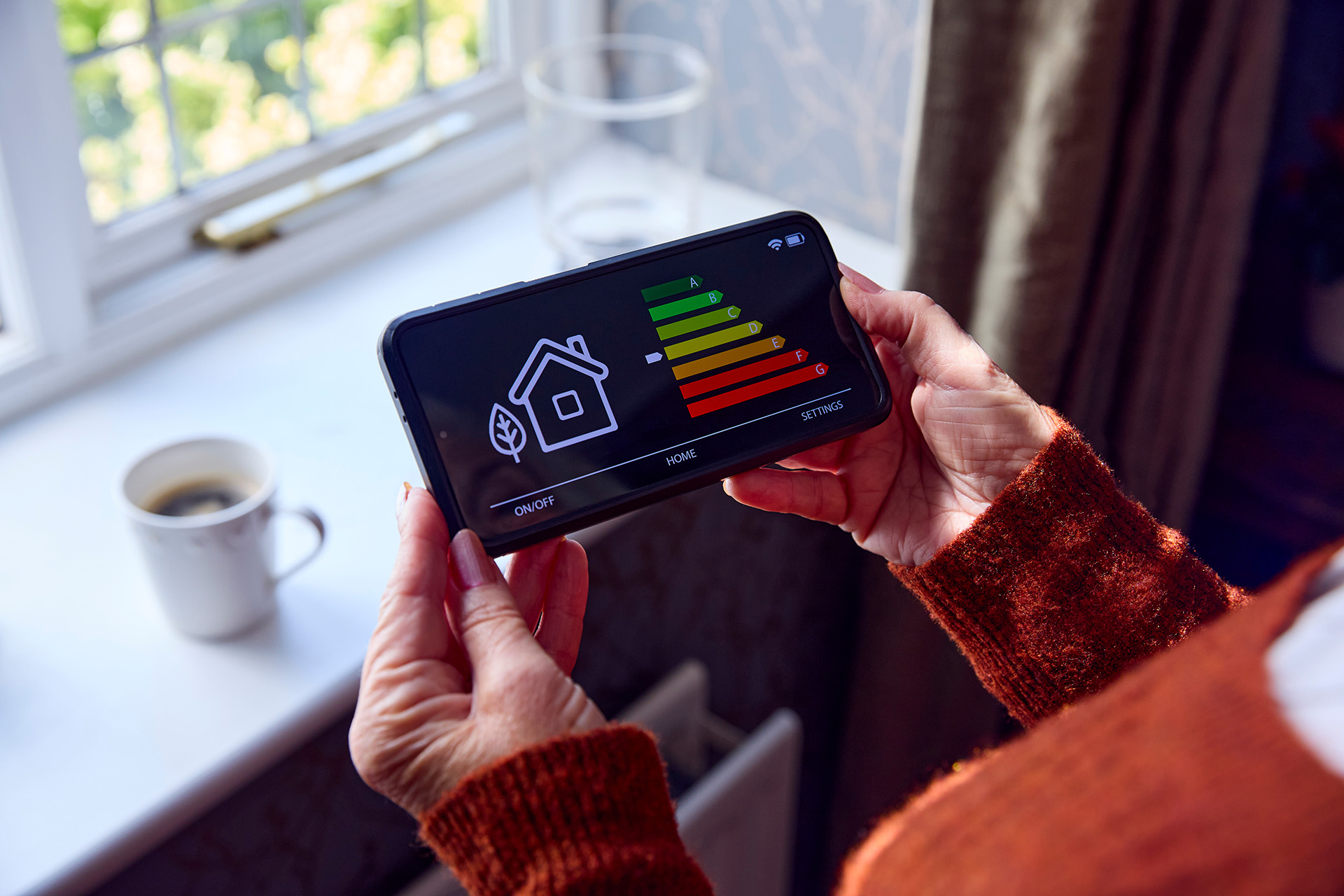 A female veteran holding a smart meter, outlining the financial support available to veterans struggling with energy costs.