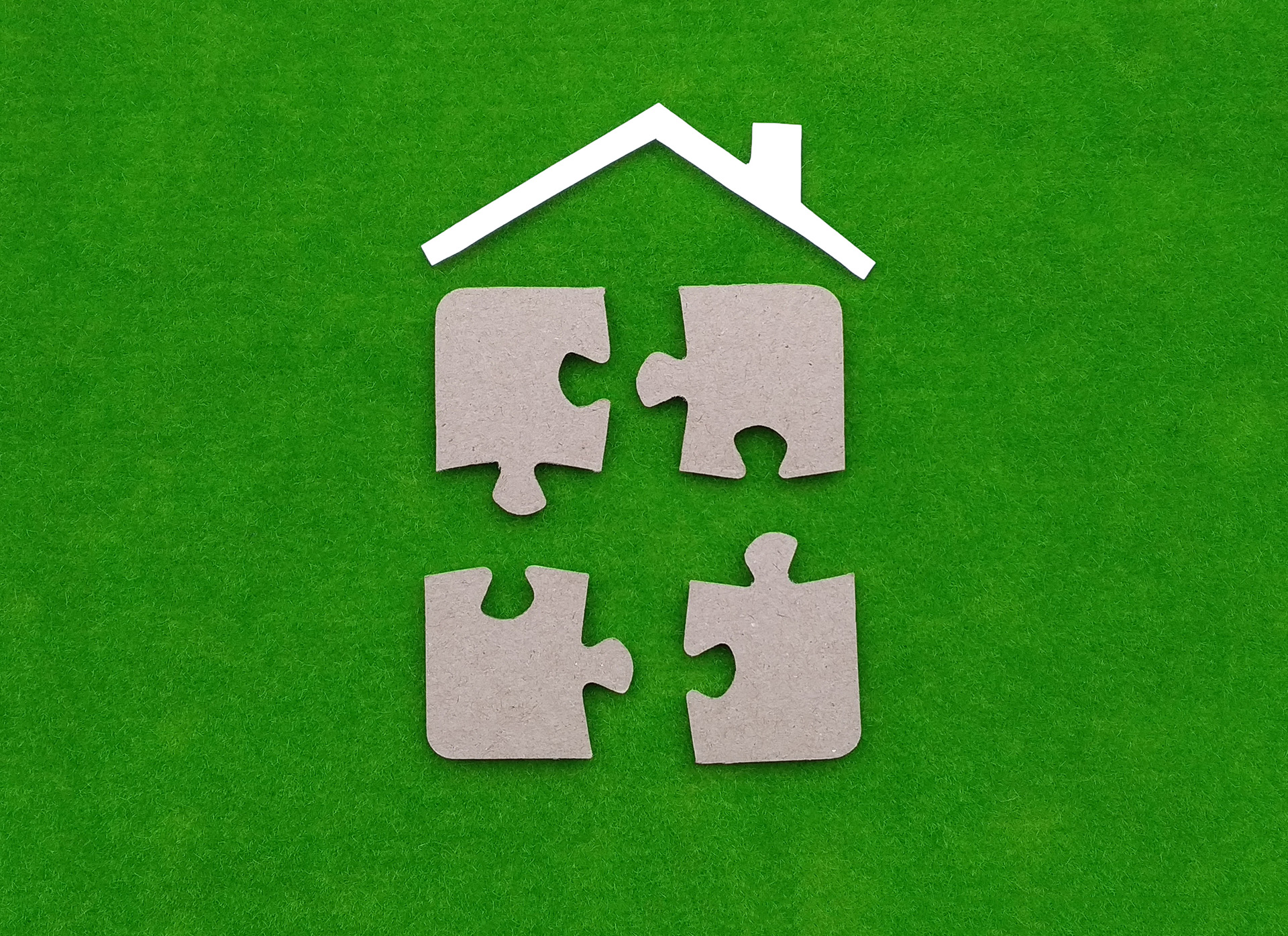 Jigsaw pieces within a house, showing how share ownership can help veterans with buying a home in England.