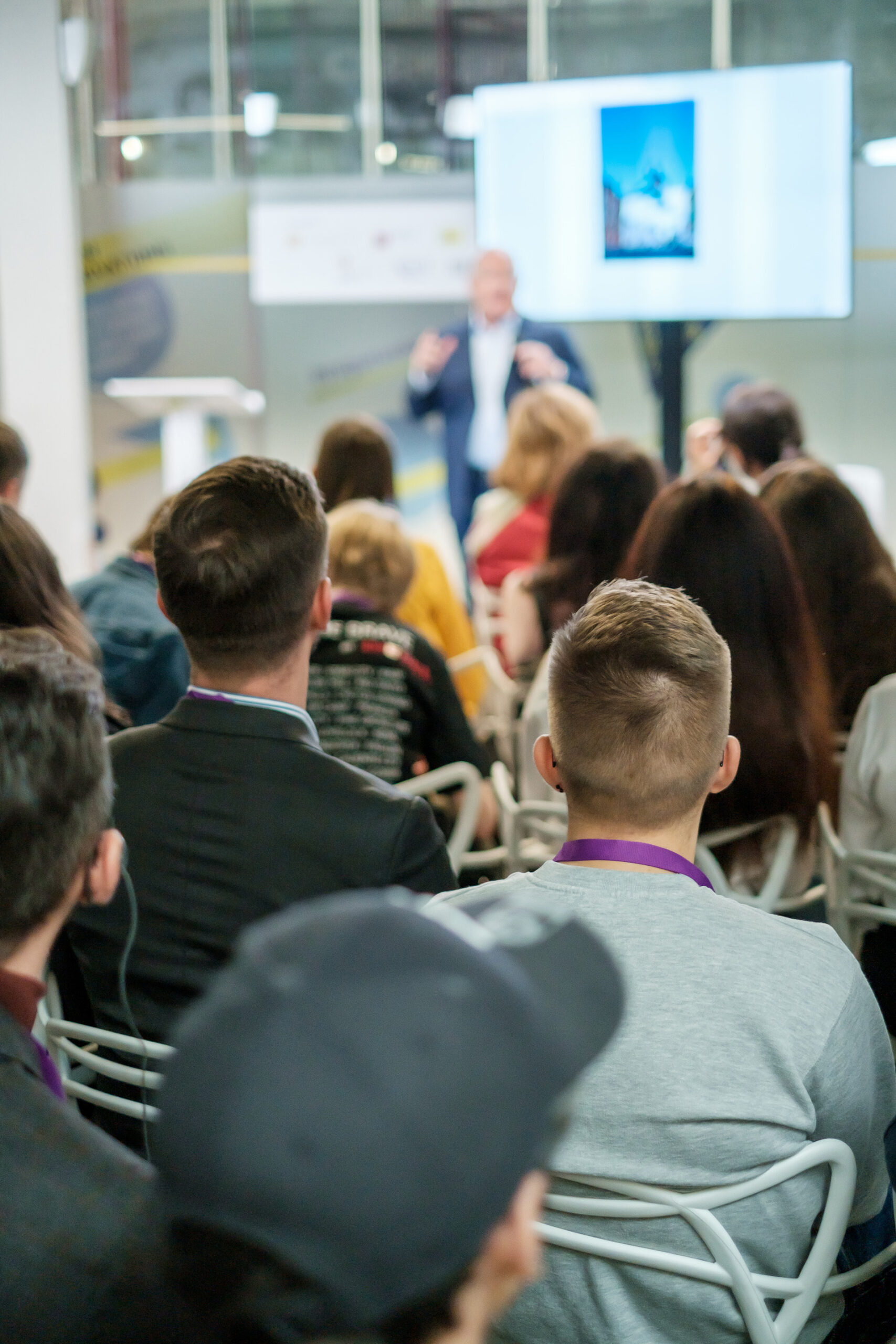 An audience listening to a speaker giving a talk on starting a business.
